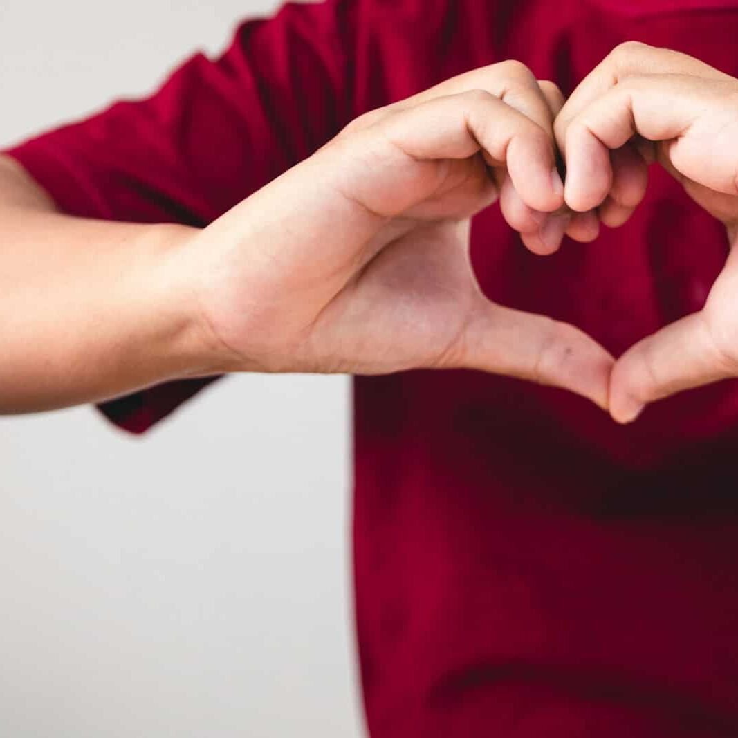 a person making a heart with their hands